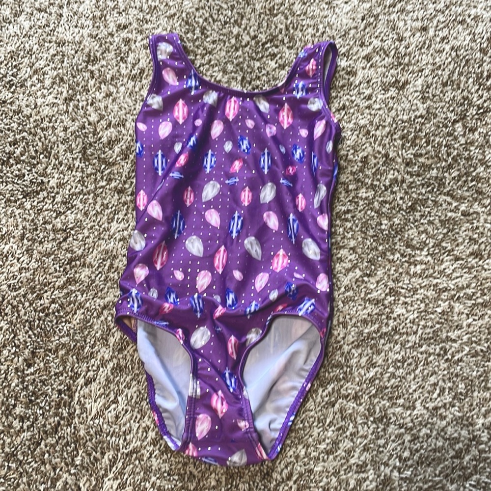 This is a leotard with purple, gray, light, pink, and pink diamonds